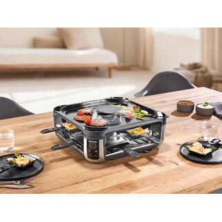 Raclette-Grill mit eingebautem Rauchabzug auf einem Tisch gedeckt.