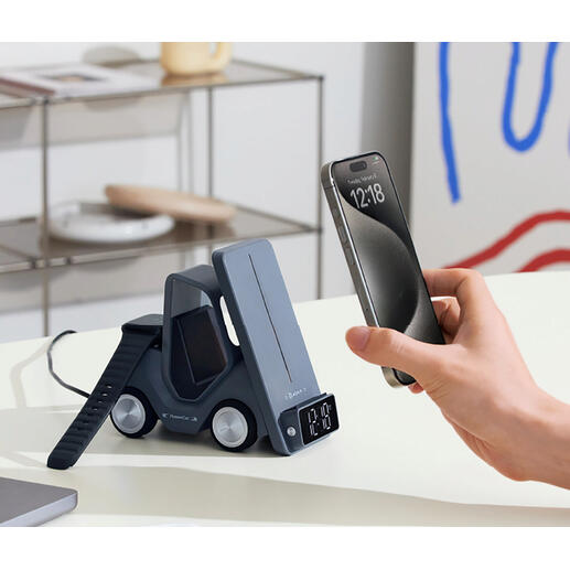 Qi-Lade-Stapler mit Smartphone, welches aufgeladen wird, und digitaler Uhranzeige.