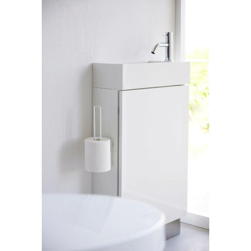 Weißer Design WC-Rollenhalter an einem modernen Badezimmermöbel angebracht.