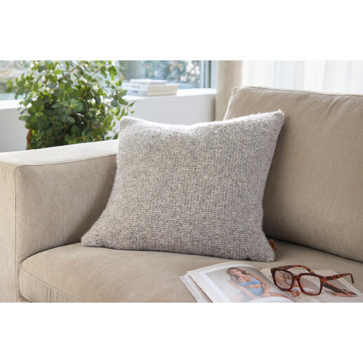 Graues Alpaka-Leinen-Kissen auf einem hellen Sofa mit Brille und Magazin.