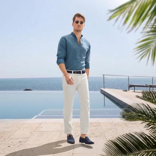 Mann in Leinen-Fischerhemd, am Meer, mit Sonnenbrille.