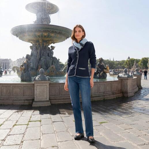 Frau in einem dunkelblauen Kaschmir-Janker vor einem Brunnen