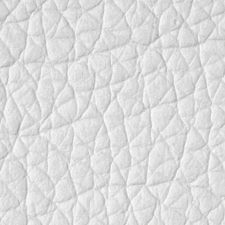 Schneeweiss Naheaufnahme der strukturierten Oberfläche eines hellen Hockers.