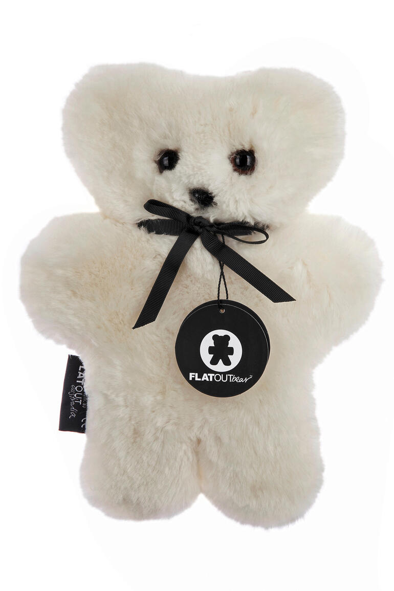 Cremeweißer Schafsfell Teddybär mit einer Schleife