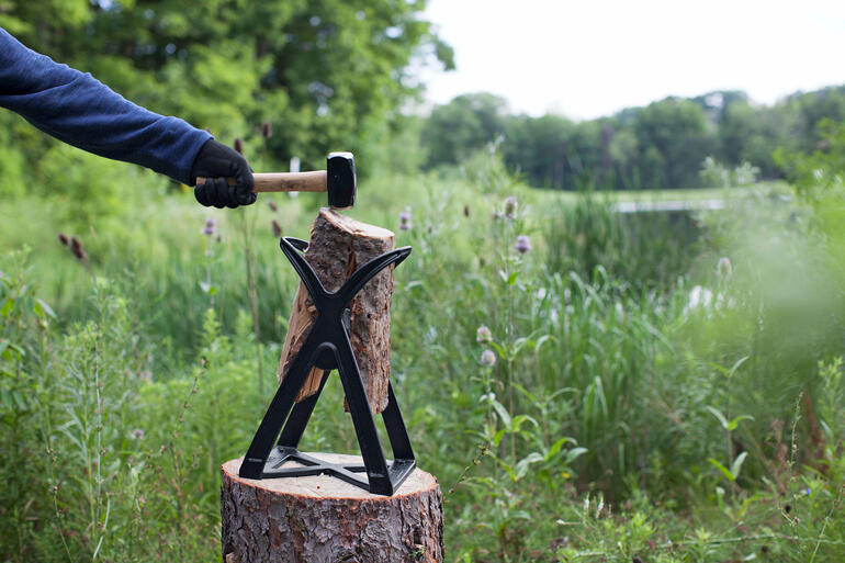 Holzscheit-Spalter mit Holzscheit im Freien