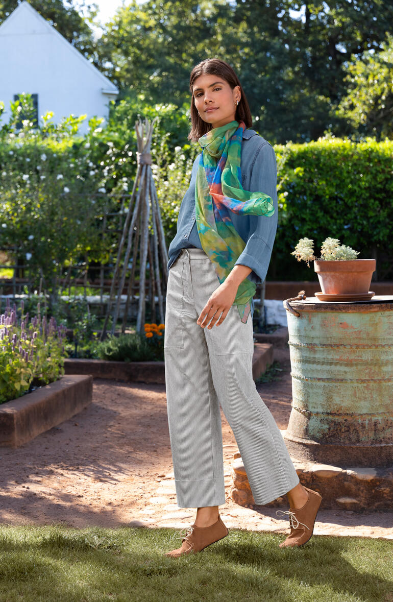Pantalon à rayures en Seersucker Bella Dahl Jeansbluse in Blau, getragen von einer Frau in einem Garten.