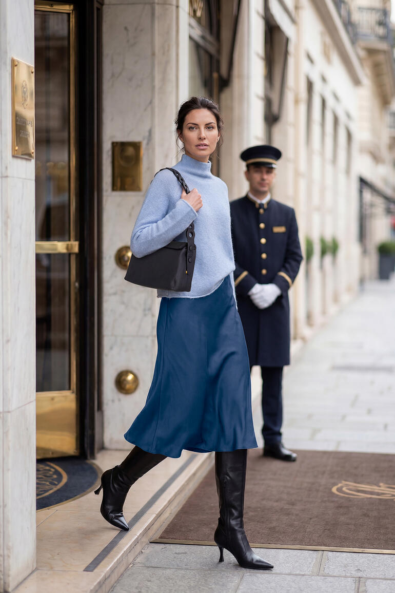 Frau in Junghans 1954 Boxy-Pullover verlässt ein Hotel